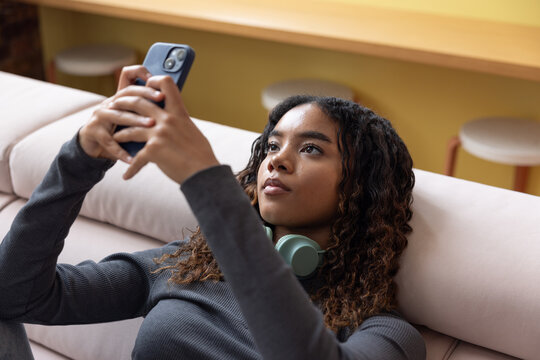 Female Student using smartphone to check personal finances 