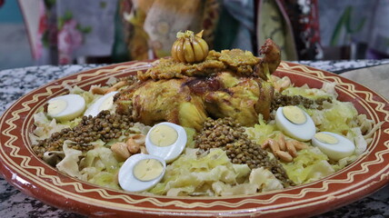 Authentic Moroccan Chicken Rfissa Dish with Lentils, Eggs, Almonds, and Spiced Shredded Bread on a Decorative Ceramic Plate - Traditional North African Cuisine for Festive and Family Gatherings  
