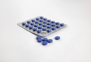 Blue Pills in Blister Pack on White Background