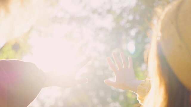 In a beautiful sunlit outdoor setting, two hands are reaching out, symbolizing the deep connection, love, and the immense joy of human interaction amidst the breathtaking beauty of nature