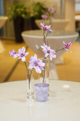 Elegant arrangement of artificial orchids in a modern indoor setting with soft lighting and contemporary decor