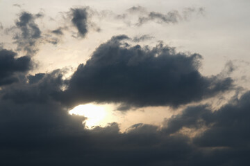 Dark clouds come with the rain and the evening sun.