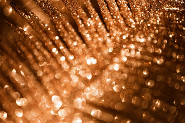 Abstract composition made of a decorative branch closeup. Defocused sparkles. Shiny festive and holiday background. Celebration and party concept.