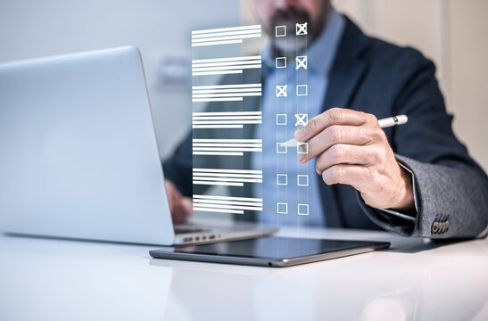 Man do online exam on virtual screen. Answer a survey filling out a tech form. Quiz, test concept