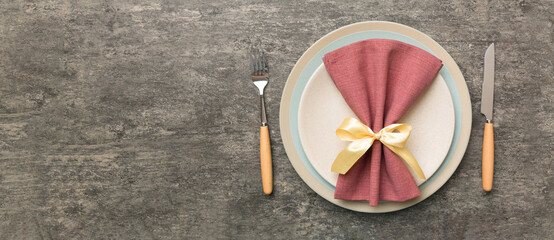 Christmas table place setting with christmas decor and plates, kine, fork and spoon. Christmas holiday background. Top view with copy space