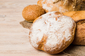 Homemade natural breads. Different kinds of fresh bread as background, perspective view with copy space