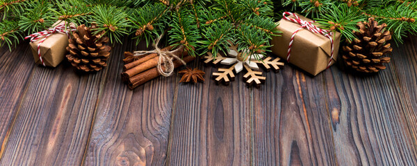 Christmas background with fir tree and gift box on wooden table. Top view with copy space for your design