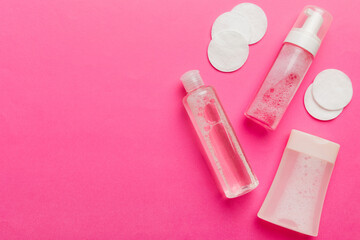 Micellar cleansing water and discs to remove cosmetics and cleanse the skin on colored background. Copy space top view
