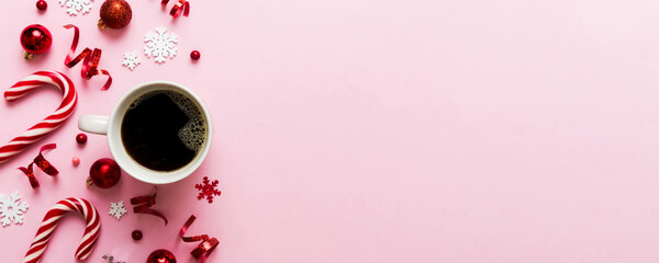 Delicious fresh festive morning coffee in a ceramic cup with little wrapped gifts, ornament and xmas toy. Cup of coffee and new year toys