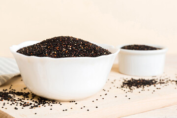 quinoa seeds in bowl on colored background. Healthy kinwa in small bowl. Healthy superfood
