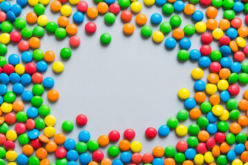 Mixed collection of colorful candy, on colored background. Flat lay, top view. frame of colorful chocolate coated candy