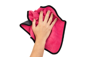 Human hand holding pink rag and wiping table or cleaning something isolated on white background with clipping path.