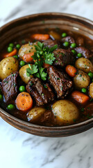 Beef stew in a bowl with potatoes, carrots, and peas.