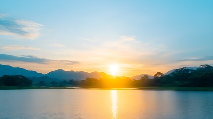 Fototapeta premium Serene sunset over a tranquil lake and mountains