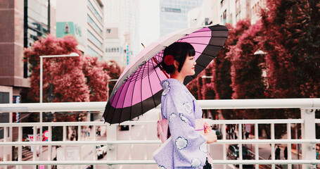 City, umbrella and woman in kimono walking on bridge with smile, morning travel or sightseeing adventure. Fashion, spring and Japanese girl in traditional clothes, parasol or culture on urban commute © peopleimages.com