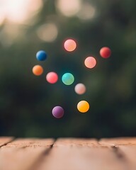Colorful spheres floating above a wooden surface