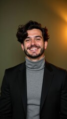 Fototapeta premium Smiling young man in formal suit with arms crossed