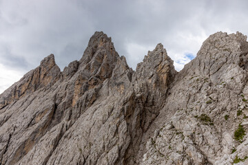 Dolomites mountains nasty weather in autumn with dark cloudy sky before the storm. Black clouds on the sky above the mountain rocky summits and peaks, stormy weather in the Dolomiti Alps, Italy