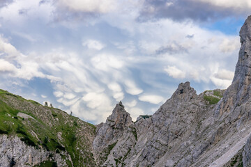 Dolomites mountains nasty weather in autumn with dark cloudy sky before the storm. Black clouds on the sky above the mountain rocky summits and peaks, stormy weather in the Dolomiti Alps, Italy