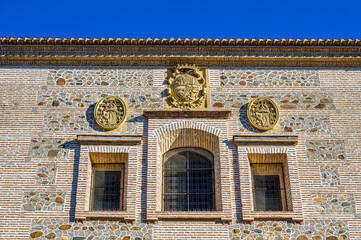 Granada, Spain, Stone-engraved symbols on a medieval wall, part of the Alhambra complex.