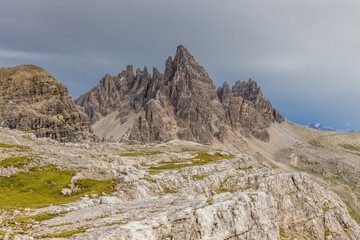 Dolomites mountains nasty weather in autumn with dark cloudy sky before the storm. Black clouds on the sky above the mountain rocky summits and peaks, stormy weather in the Dolomiti Alps, Italy