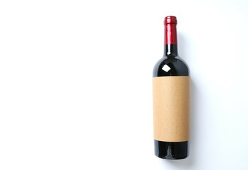 Bottle of red wine on a white background. Top view with copy space for text