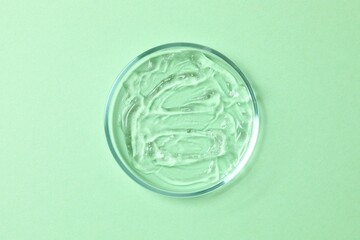 Petri dish, cosmetic gel swatches with aloe on white background, copy space. Bio science research, biochemistry, organic skin care concept
