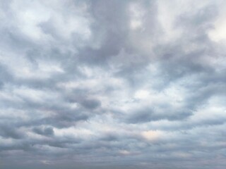 the grey overcast sky. A sweeping pattern of clouds evolving as an intricate background pattern....