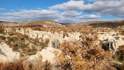 Beautiful scene of the valley with rock formations and fairy chimneys formed by the erosion of white volcanic tuff cliffs in the northeast of Ayazini Village in the autumn