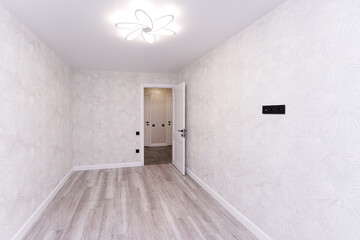 empty room without furniture in light colors with a chandelier and curtains