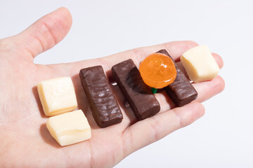 Chocolate and creme caramel orange lollipop in your hand