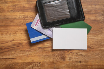 Empty business card with a wallet, money, credit cards.