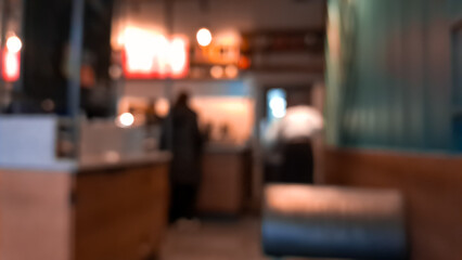 Cozy blurred coffee shop background in warm brown tones, inviting atmosphere.