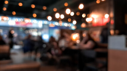 Cozy blurred coffee shop background in warm brown tones, inviting atmosphere.