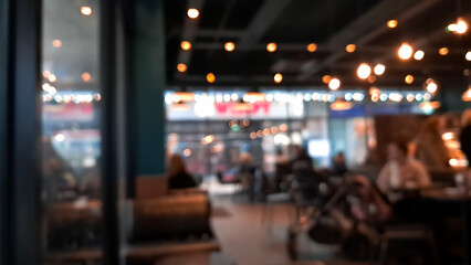 Cozy blurred coffee shop background in warm brown tones, inviting atmosphere.