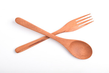 Wooden spoon and fork, crossed as road sign, isolated on white background. Houseware