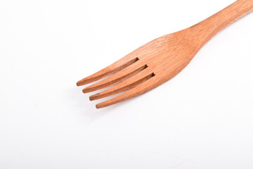 Close up of Wooden fork isolated on white background. Kitchen utensils