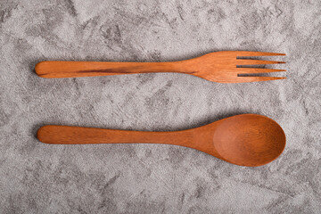 Top view of Wooden spoon and fork on table. A set of kitchen utensils