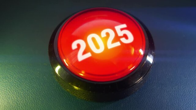 Pressing the big red button labeled with the message "2025"