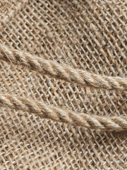 burlap - rough embossed texture of natural fabric with rope elements close-up background