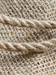 burlap - rough embossed texture of natural fabric with rope elements close-up background