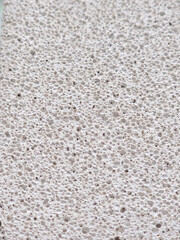 porous texture of pumice stone light gray color close-up background