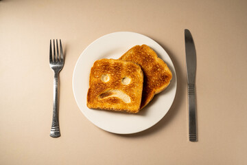 Gluten food, slice of toasted bread with sad face. Gluten allergy.