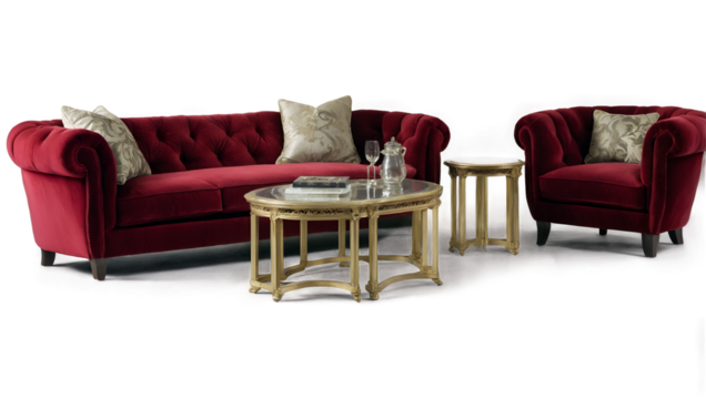 Luxurious red sofa and armchair set with ornate pillows, paired with a sophisticated gold coffee table, creating an elegant and cozy living room ambiance.