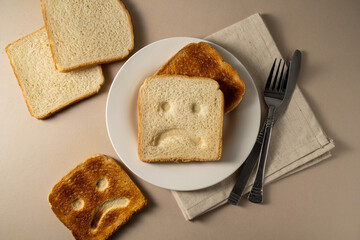 Gluten allergy, slice of fresh toast bread with sad face. Gluten free food.