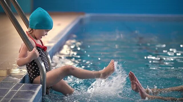 Family in the pool. kid fooling around. slow motion video. high quality footage 4k
