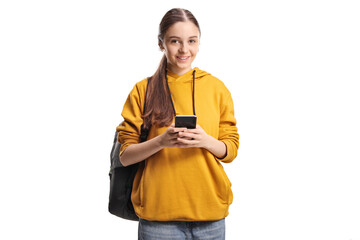 Female teenage student using a smartphone and smiling at camera