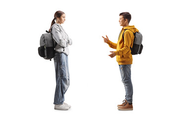 Fototapeta premium Male and female teenage students standing and talking