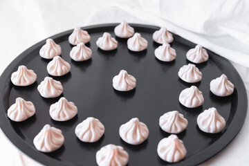 A top-down view of khinkali magnets on a black tray, arranged symmetrically for a stylish and modern food-inspired design that enhances your kitchen decor