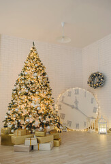 A beautifully decorated Christmas tree stands in front of a brick wall, surrounded by presents and a large clock. The tree is adorned with gold and silver ornaments and lights.